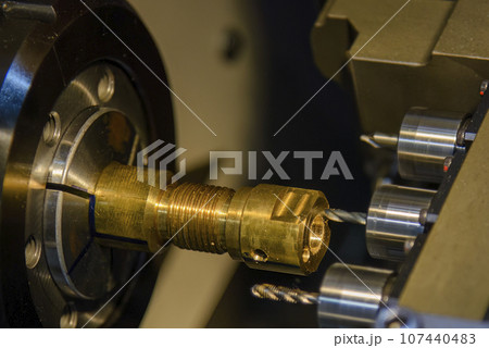 The multi tasking CNC lathe machine swiss type drilling the brass fitting parts. The multi tasking CNC lathe machine swiss type drilling the brass fitting parts. 107440483