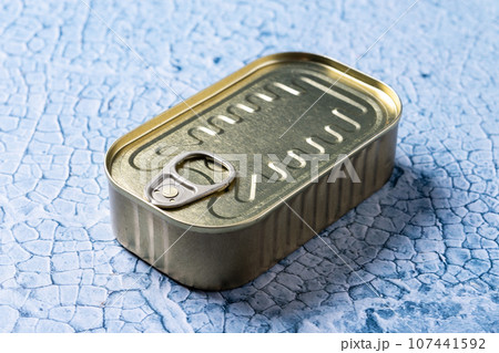 Canned food in metal can on blue background 107441592