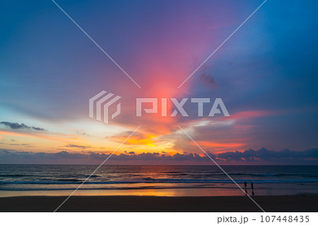 amazing pink sky above Karon beach Phuket at colorful sunset. sweet sky in colorful sunset above the ocean. Imagine a fantasy bright pink in blue sky at sunset. Sky texture background. 107448435
