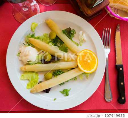 Baked white asparagus with greens Baked white asparagus with greens 107449936