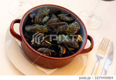 French dish - mussels with green sauce in copper cooking dish French dish - mussels with green sauce in copper cooking dish 107449964