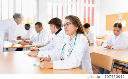 Portrait of doctors different age who writing exercises at lesson Portrait of doctors different age who writing exercises at lesson 107450012