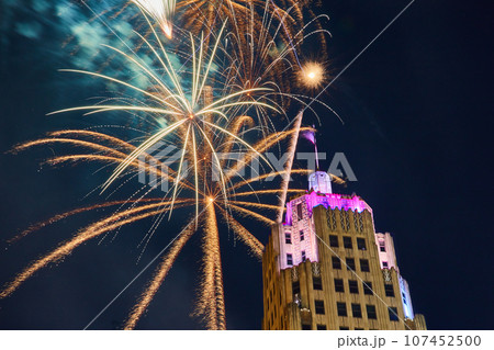 Gold fireworks behind Lincoln Tower downtown Fort Wayne on 4th of July with purple lights 107452500