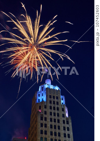 Downtown Fort Wayne Lincoln Tower with blue lights and golden 4th of July fireworks overhead Downtown Fort Wayne Lincoln Tower with blue lights and golden 4th of July fireworks overhead 107452603