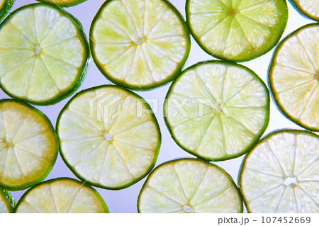 Macro close up of lime slices on white background Macro close up of lime slices on white background 107452669
