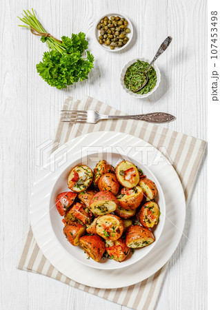 Herbs Garlic Potatoes in white bowl, top view 107453498