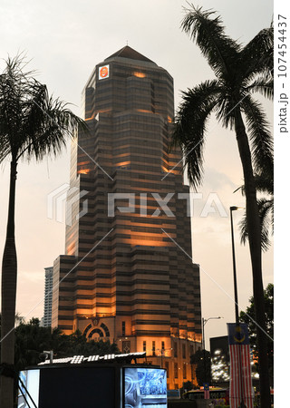 Kuala Lumpur, Malaysia - 26 August 2023: Public bank building near Petronas twins tower from close up point of view in the evening Kuala Lumpur, Malaysia - 26 August 2023: Public bank building near Petronas twins tower from close up point of view in the evening 107454437