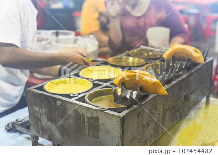 Apam Balik or Apom Balik traditional Malaysian pancake in Jalar Alor street food in Kuala Lumpur 107454482
