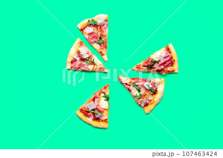 Pizza prosciutto slices minimalist on a green background 107463424