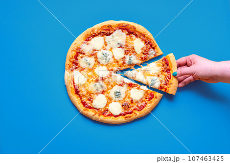 Pizza quattro formaggi, top view on a blue table 107463425