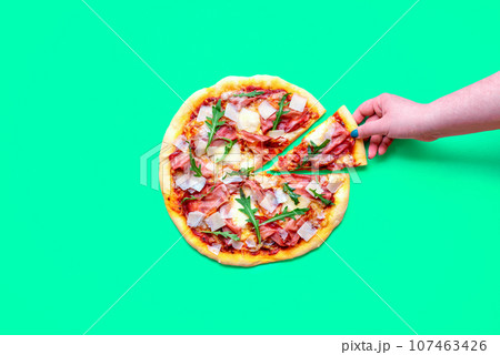 Prosciutto pizza above view, minimalist on a green background 107463426