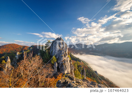 Mountain landscape with foggy valley during autumn morning. 107464023