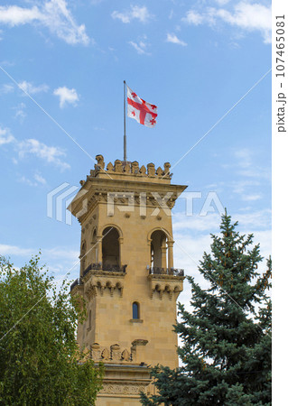 Georgia flag on the roof of an ancient tower against the clear blue sky Georgia flag on the roof of an ancient tower against the clear blue sky 107465081