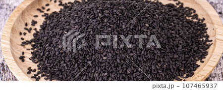 Close up of black rice on wooden surface Close up of black rice on wooden surface 107465937