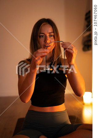 Portrait of a girl holding Tibetan bells for sound therapy. Tibetan plates 107467060