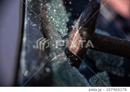 Car thief breaks the car window Car thief breaks the car window 107468176