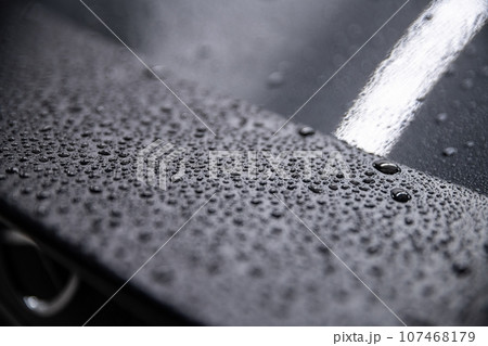 Water droplets on a carbon spoiler of a modern car. Water droplets on a carbon spoiler of a modern car. 107468179