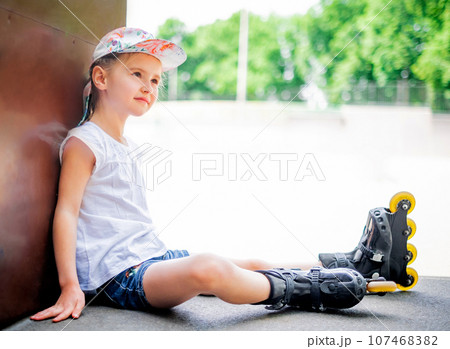 Beautiful little girl on roller skates in park Beautiful little girl on roller skates in park 107468382