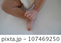 Newborn baby's legs and tiny feet. 107469250