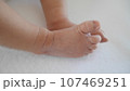 Newborn baby's legs and tiny feet. 107469251