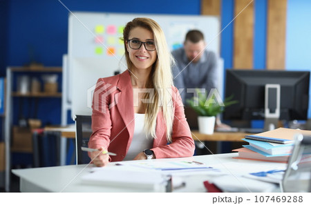 Portrait of smiling business woman in glasses in office Portrait of smiling business woman in glasses in office 107469288