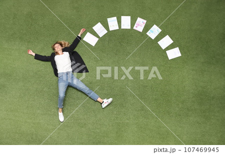 Woman is lying on green lawn along with chart business analytics 107469945