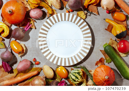 autumn flat lay on grey background with pumpkins 107470239