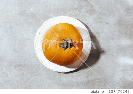 autumn flat lay on grey background with pumpkins 107470242