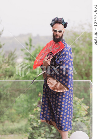 Young man wearing bathrobe night suit posing outdoor Young man wearing bathrobe night suit posing outdoor 107473601