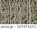 Dark brown handmade knitting blanket background. 107474251