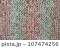 Light pastel colored stripy handmade knitting blanket background. 107474256