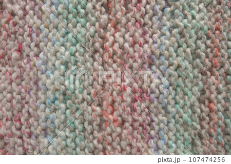 Light pastel colored stripy handmade knitting blanket background. 107474256