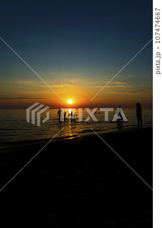 People relax and swim in the sea, before a beautiful sunset, enjoy the sunset. 107474667