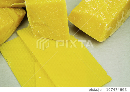 large pieces of natural beeswax, close-up, raw materials for candles. 107474668