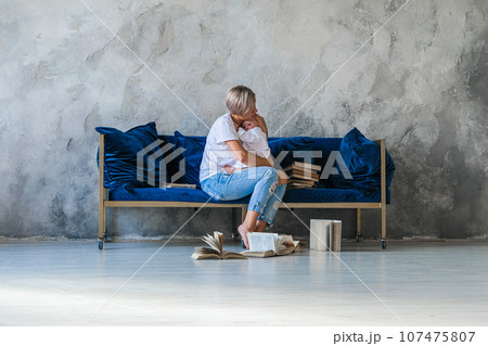 Girl sitting on sofa .Girl reading book Girl sitting on sofa .Girl reading book 107475807