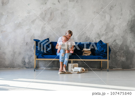 Girl sitting on sofa .Girl reading book Girl sitting on sofa .Girl reading book 107475840