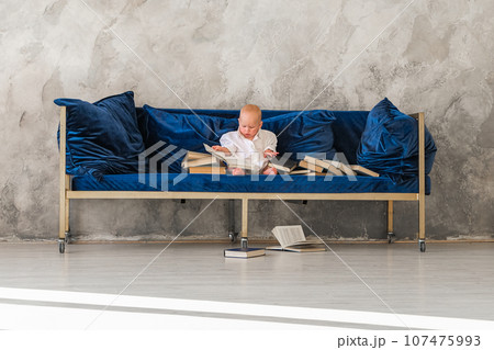 Girl sitting on sofa .Girl reading book Girl sitting on sofa .Girl reading book 107475993