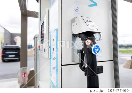 Close-up detail view of hydrogen fuel filler nozzle nozzle adapter car H2 gas filling station in Germany. Refueling vehicle with renewable innovative zero emission product. Future safety technology Close-up detail view of hydrogen fuel filler nozzle nozzle adapter car H2 gas filling station in Germany. Refueling vehicle with renewable innovative zero emission product. Future safety technology 107477460