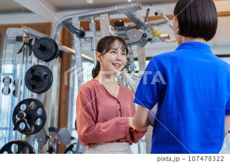 パーソナルジムの説明を受ける女性 107478322