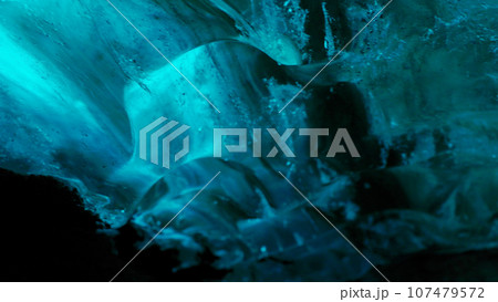 Vatnajokull glacier hiking in crevasse, nordic landscape inside ice cave with blue ice rocks. Frosty polar icebergs with cracked frozen structure, icelandic freezing cold destination . Handheld shot. Vatnajokull glacier hiking in crevasse, nordic landscape inside ice cave with blue ice rocks. Frosty polar icebergs with cracked frozen structure, icelandic freezing cold destination . Handheld shot. 107479572