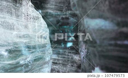 Inside crevasse in vatnajokull polar cap with cracked ice blocks structure, covered frost landscape. Massive transparent glacier in wintry icelandic scenery, icy frosty rocks. Handheld shot. 107479573
