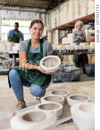 Positive woman potter with mould for new ware Positive woman potter with mould for new ware 107481733