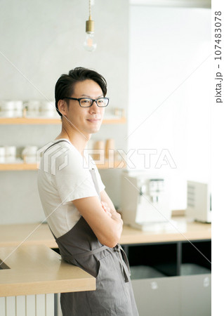 キッチンで腕組みする男性 107483078