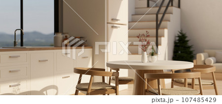 A beautiful minimal dining table in a minimal white Scandinavian kitchen design. 107485429