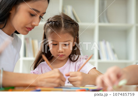 An adorable Asian elementary school girl is focusing on studying. Kids education concept 107485759