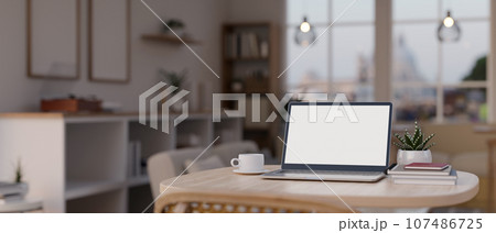 Close-up image of a laptop mockup on a table in a modern cozy room. Close-up image of a laptop mockup on a table in a modern cozy room. 107486725