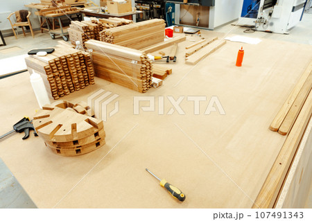 Stacked wooden bars in workshop of furniture manufacture Stacked wooden bars in workshop of furniture manufacture 107491343