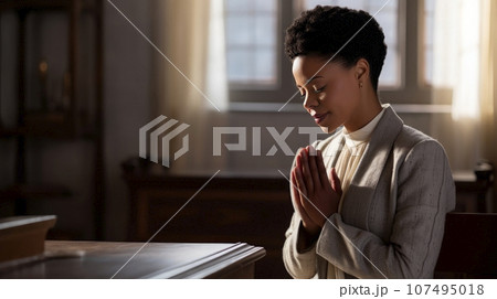 Black woman praying or meditating Black woman praying or meditating 107495018