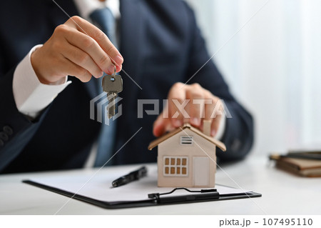 Realtor or bank manager holding keys. Real estate, property investment and loan concept 107495110