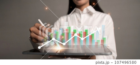 Business woman using tablet to analysis sale data and economic and technology growth graph chart on global network Business woman using tablet to analysis sale data and economic and technology growth graph chart on global network 107496580